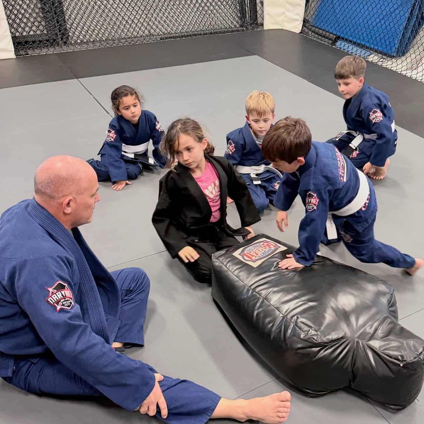 Coach Jamie instructing a group during kids class.
