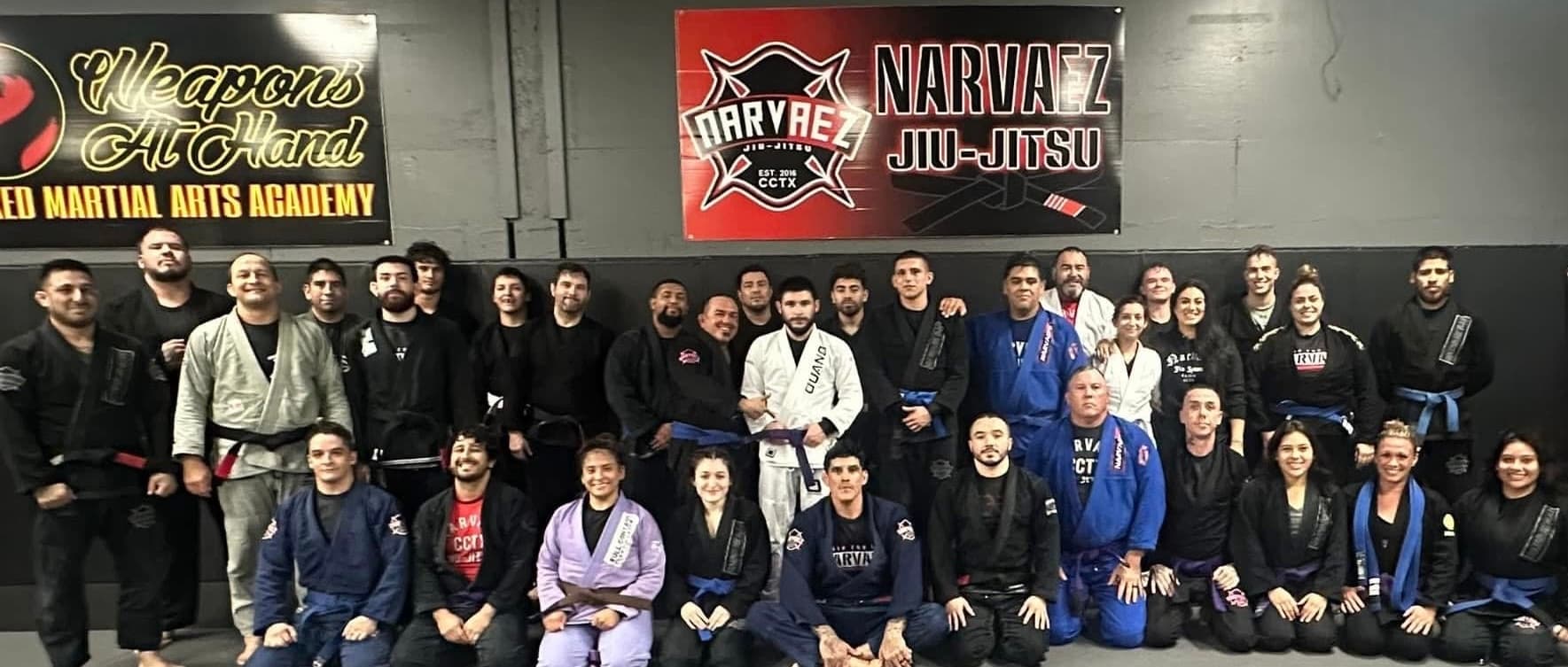Belts of different colors lined up at the edge of the mat